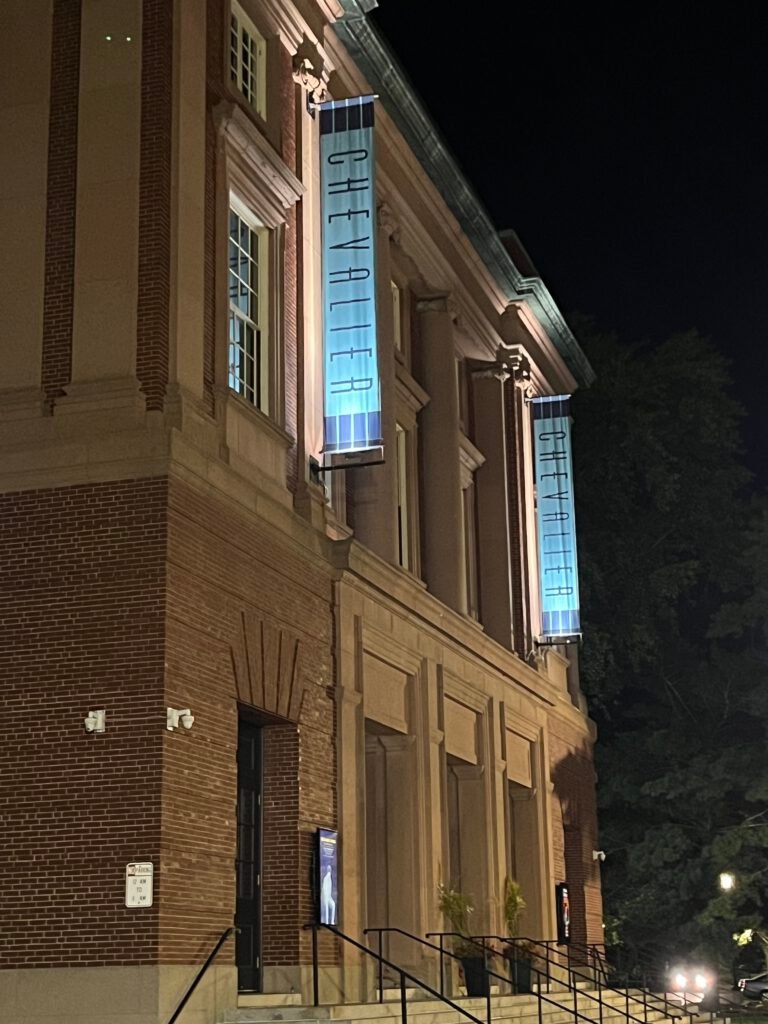 Outside of the Chevalier Theatre at night with new LED lights lighting up banners.